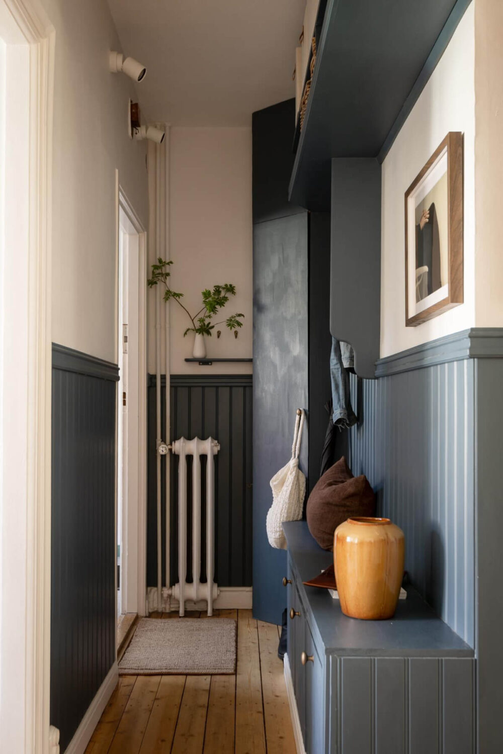 A Cozy Swedish Apartment with a Walk-In Pantry in the Sage Green Kitchen 31 blue joinery hall with bench and storage