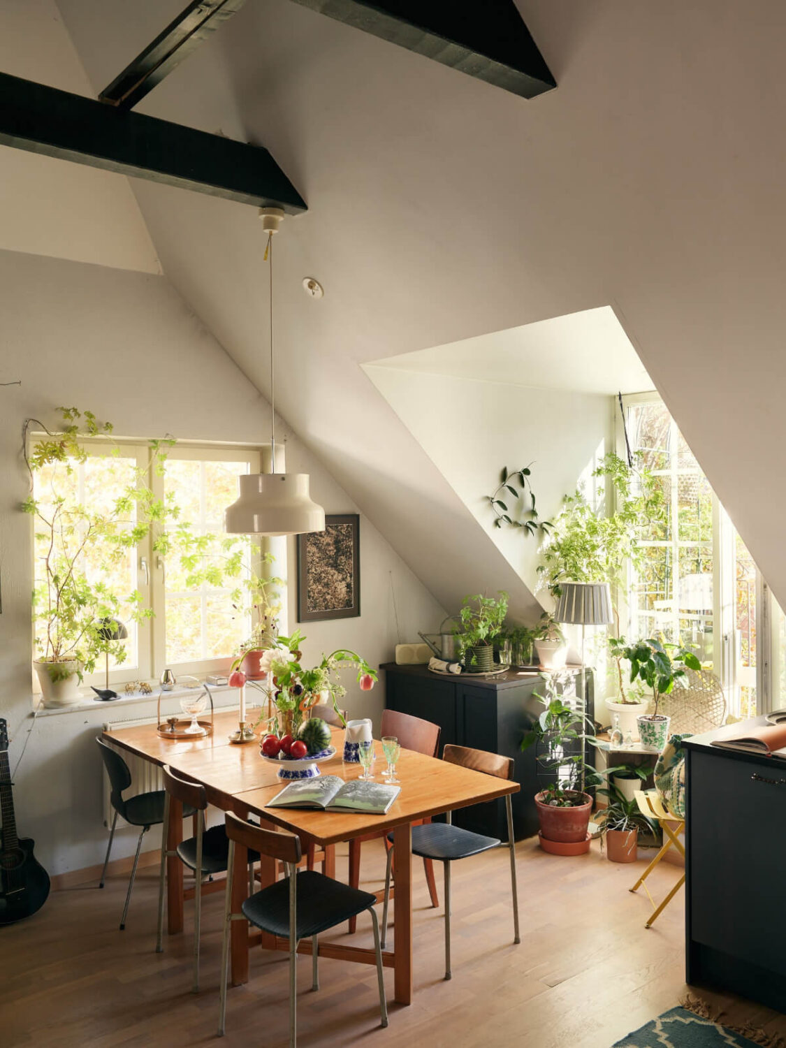 A Stunning Top-Floor Apartment with High Ceilings in a Former Church 4 cozy kitchen dining table plants high ceilings