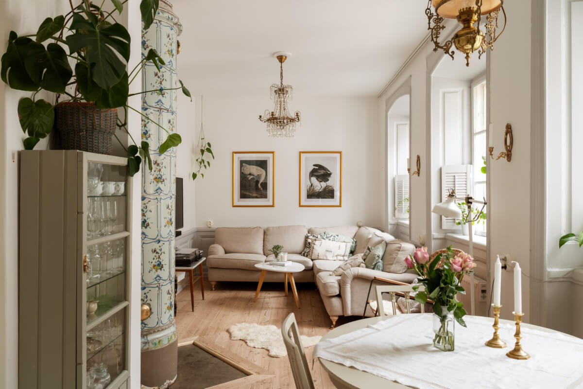 A Charming Attic Apartment in Stockholm's Gamla Stan 1 cozy living room large windows painted fireplace