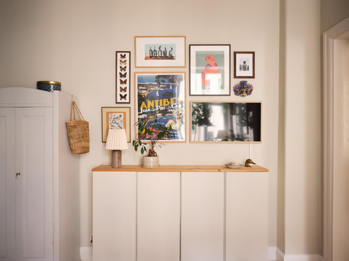 A Cozy, Tiny Apartment with a Golden Yellow Bedroom 4 floating cabinets gallery wall