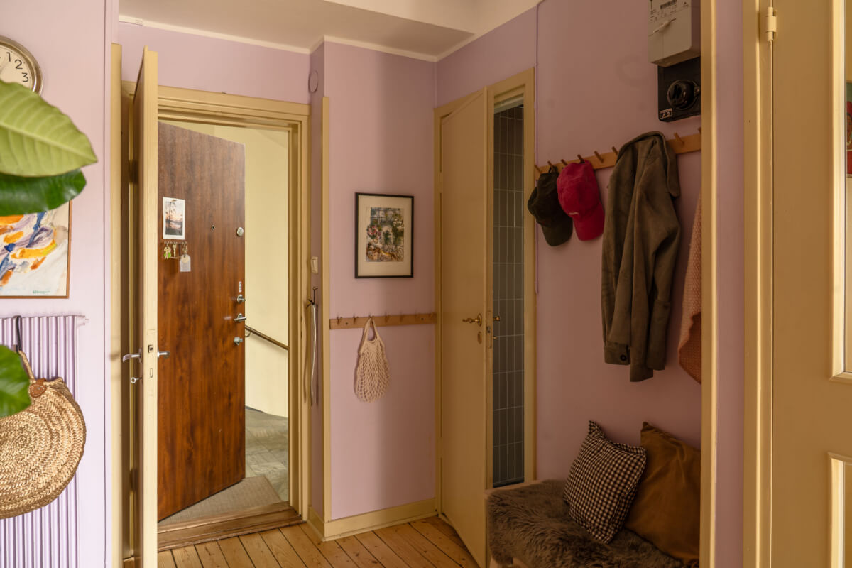 A Stylish and Joyful Color and Material Palette in a Midcentury Apartment 29 hall lilac walls butter yellow doors and woodwork
