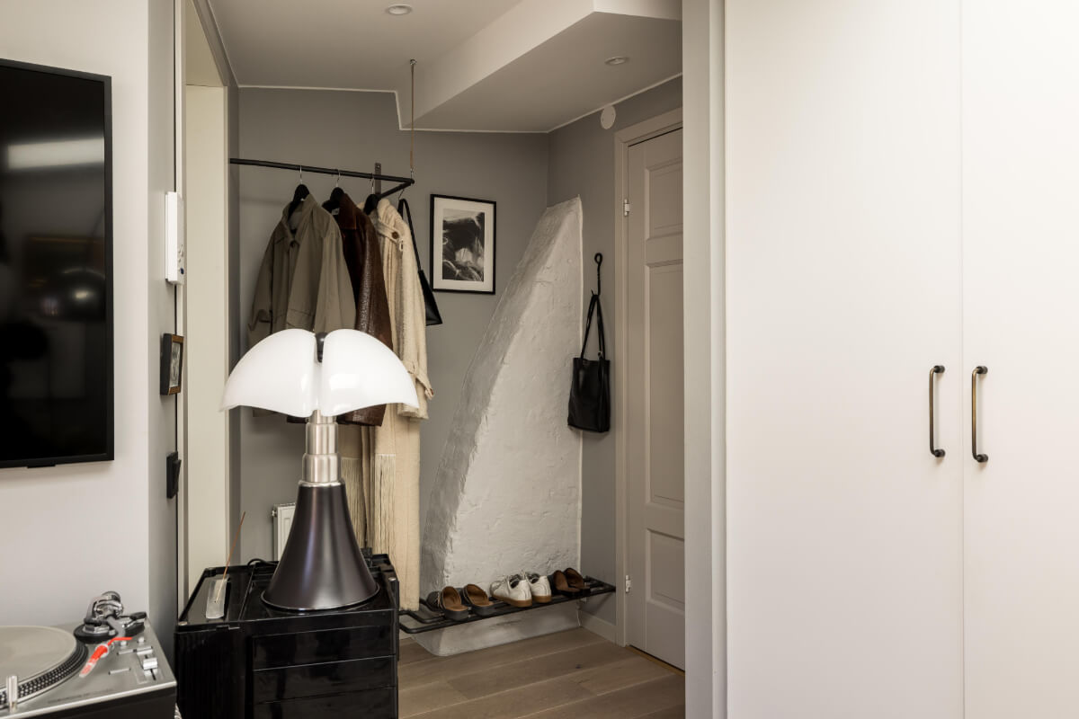 A Small, Cozy Attic Apartment with a Large Terrace 15 hall with coat rack and stone wall A Small, Cozy Attic Apartment with a Large Terrace