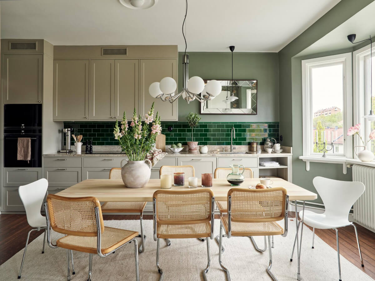 A Harmonious Color Palette in a Swedish Duplex Apartment 1 kitchen large dining table green backsplash tiles