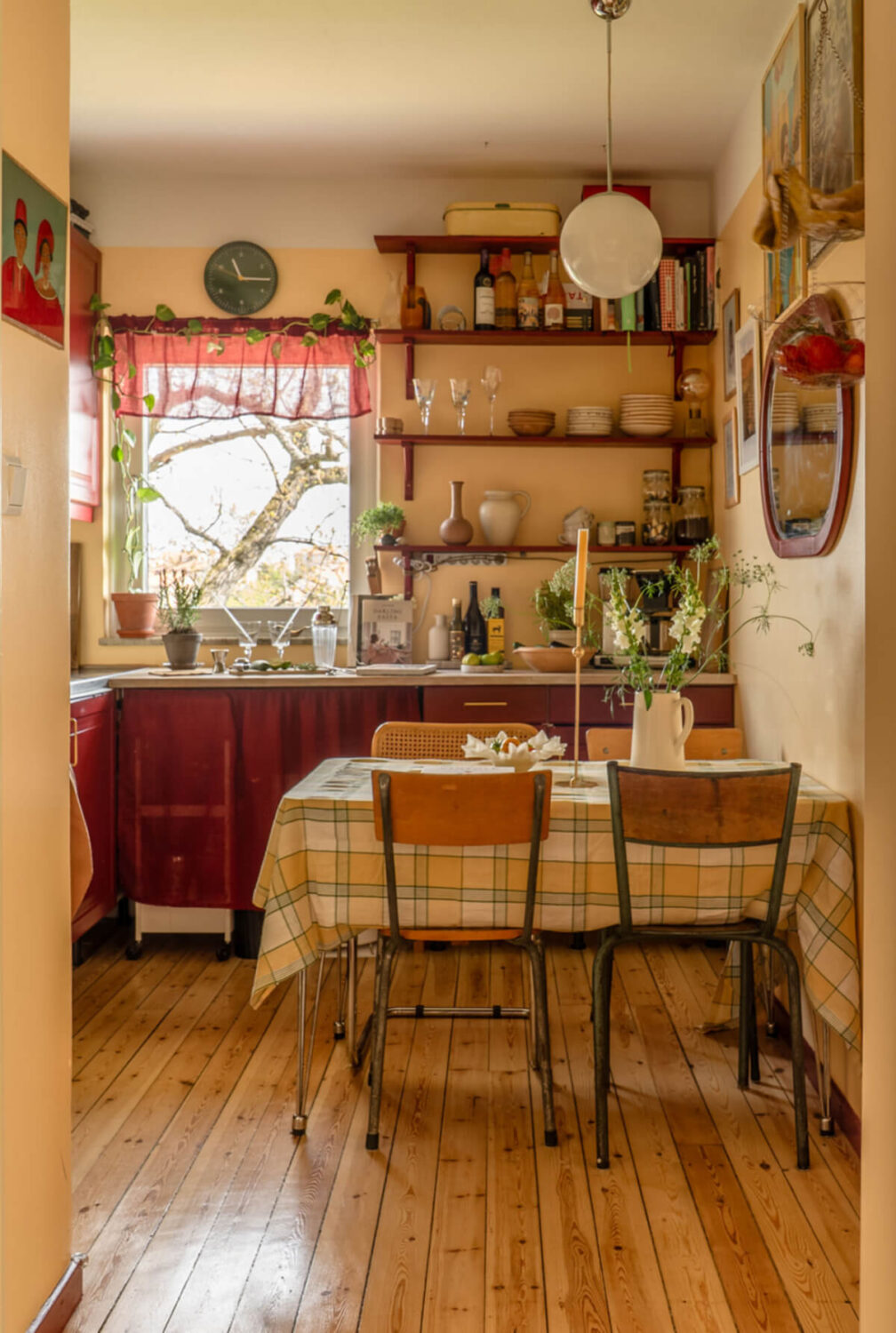 PPG & Glidden Color of the Year 2026: Warm Mahogany 11 kitchen with dining table wooden floor deep red cabinets and shelves