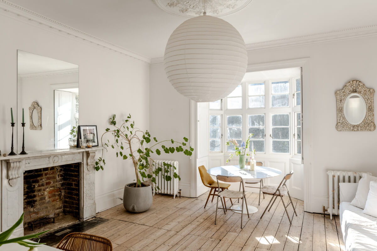 Grand, Light-Filled Spaces in a Gothic-Style English Coastal Home 12 large kitchen space fireplace wooden floor round table