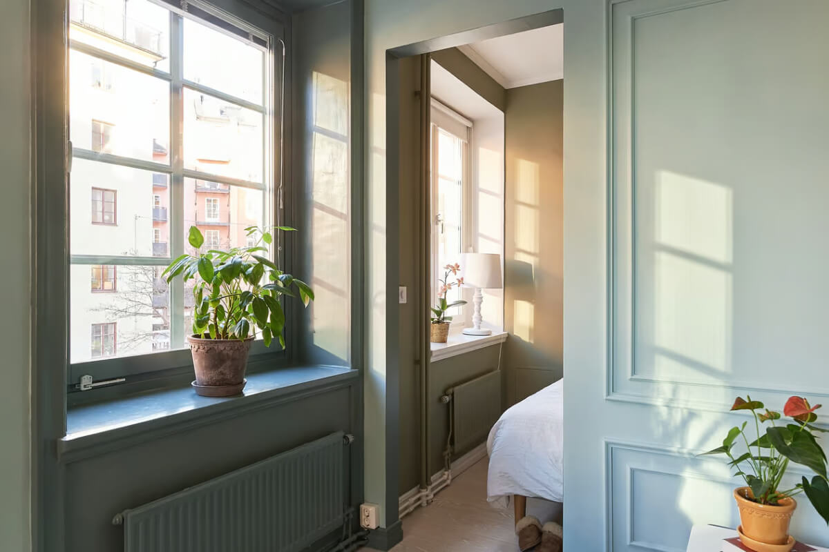 A Green Swedish Corner Apartment with an Open Floor Plan 12 large windows deep niches