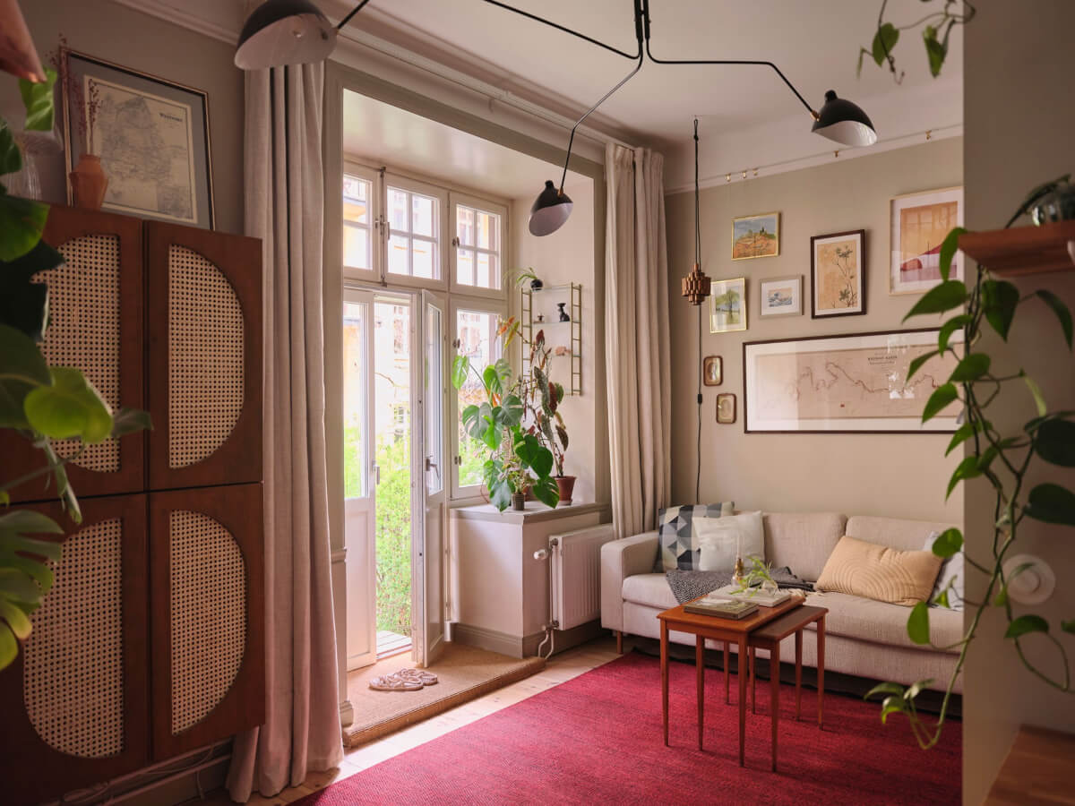 A Fantastic Small Art Nouveau Apartment in Stockholm 9 small living room dark pink rug gray walls nordroom
