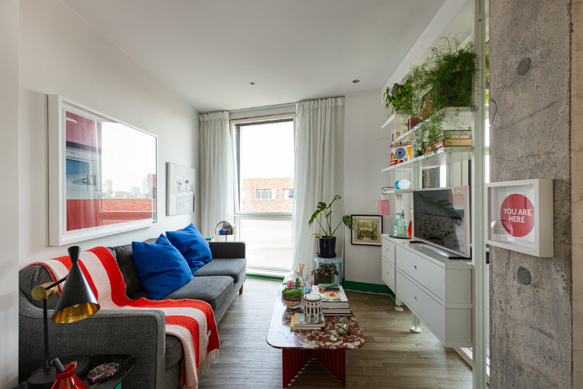 Playful Colors in a Modern One-Bedroom Apartment in London 3 small living room white shelving system