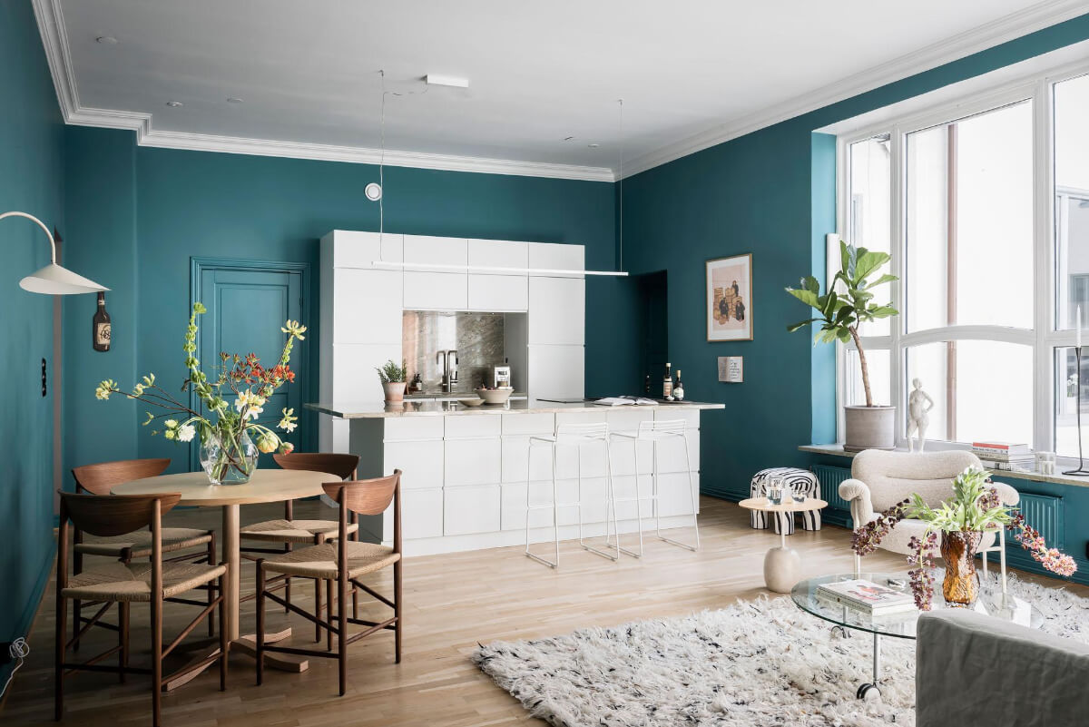 A Teal Green Living Room and Large Windows in a Swedish Apartment 9 white kitchen round dining table open plan living space