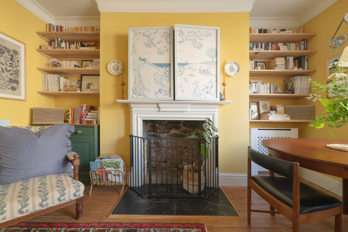 A Family Home with a Cheerful Color Palette in a Historic House 2 yellow living room fireplace bookshelves