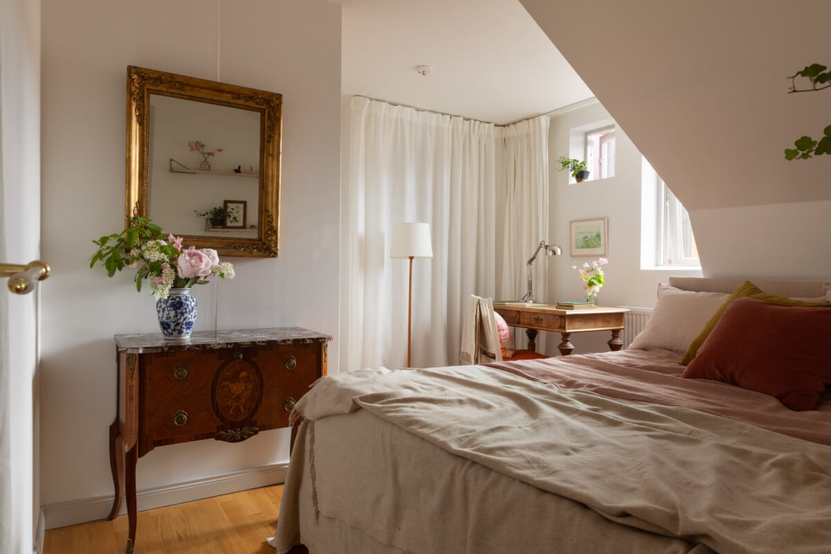 Antiques and Modern Additions in a Cozy Top Floor Duplex Apartment 24 cozy attic bedroom storage behind curtains