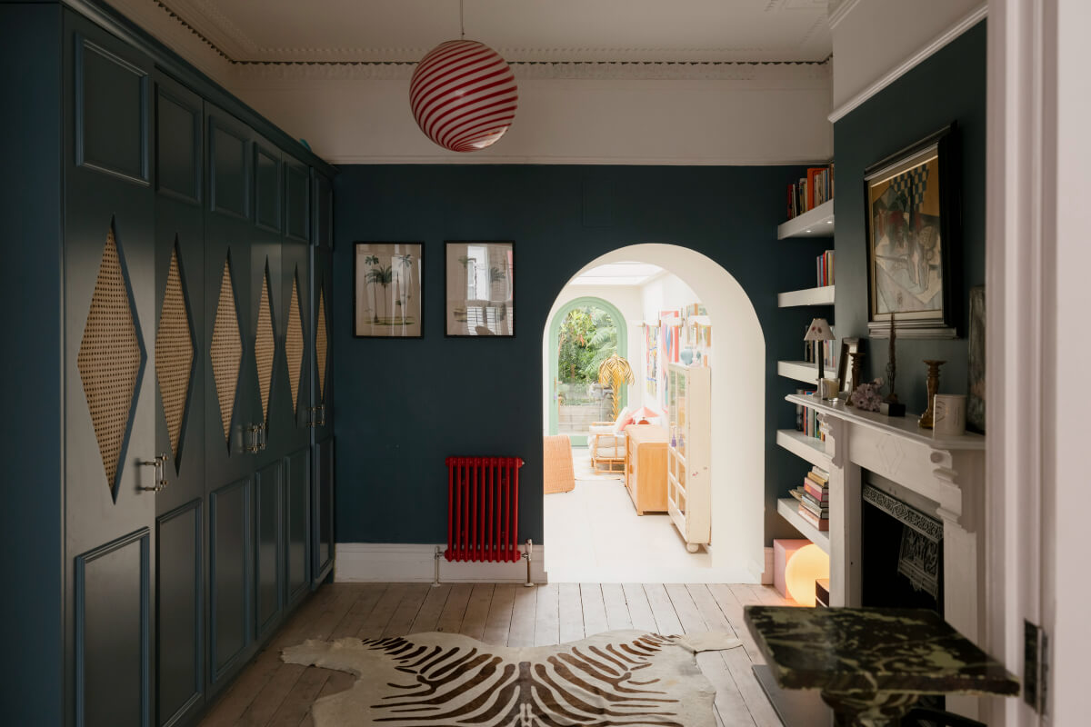 A Victorian Family House with a Tuscan-Inspired Kitchen Extension 6 dark blue room built-in cabinets fireplace
