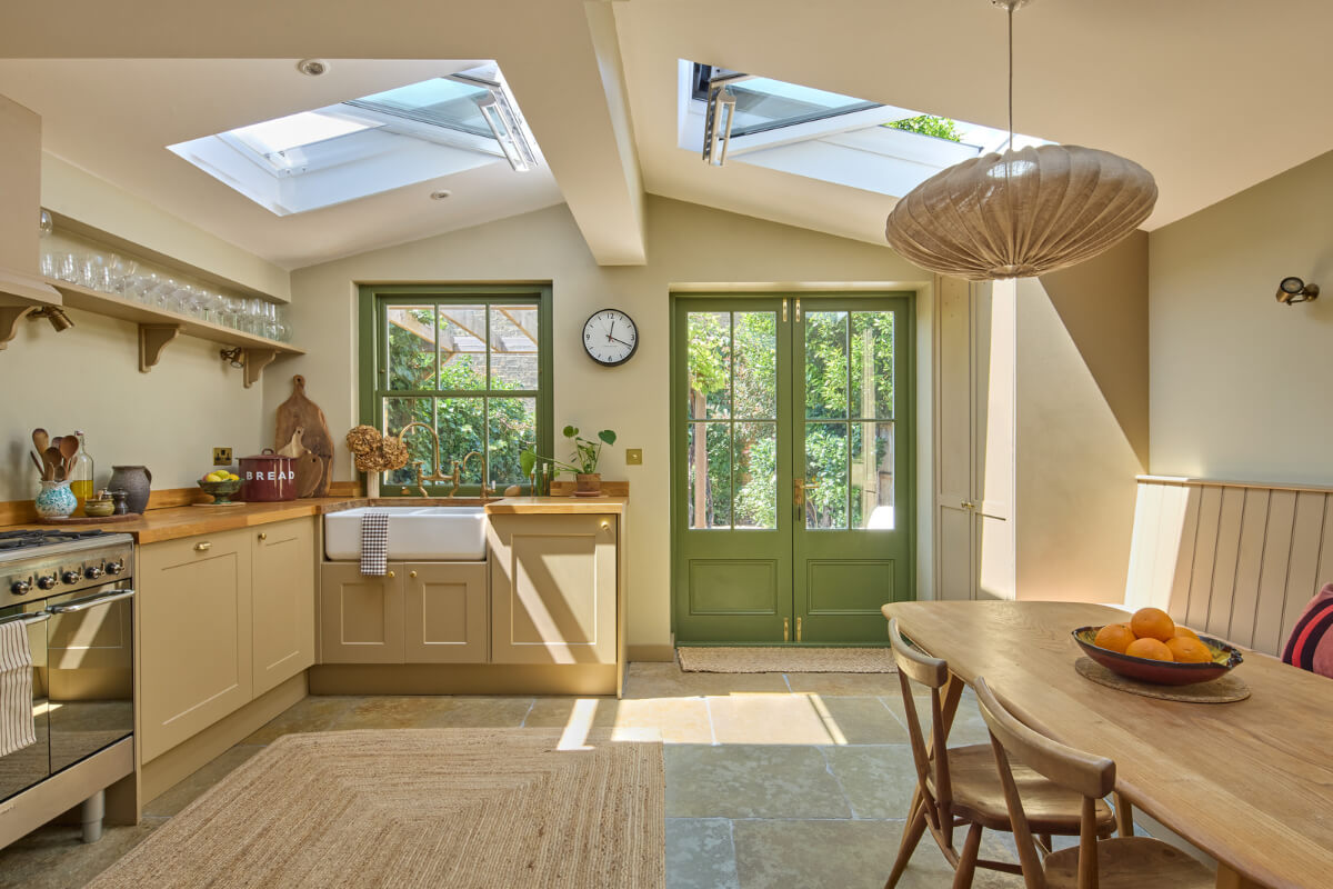 A 19th Century London Cottage with a Stunning Kitchen Extension 5 extended kitchen with large skylights stone floor green window frames
