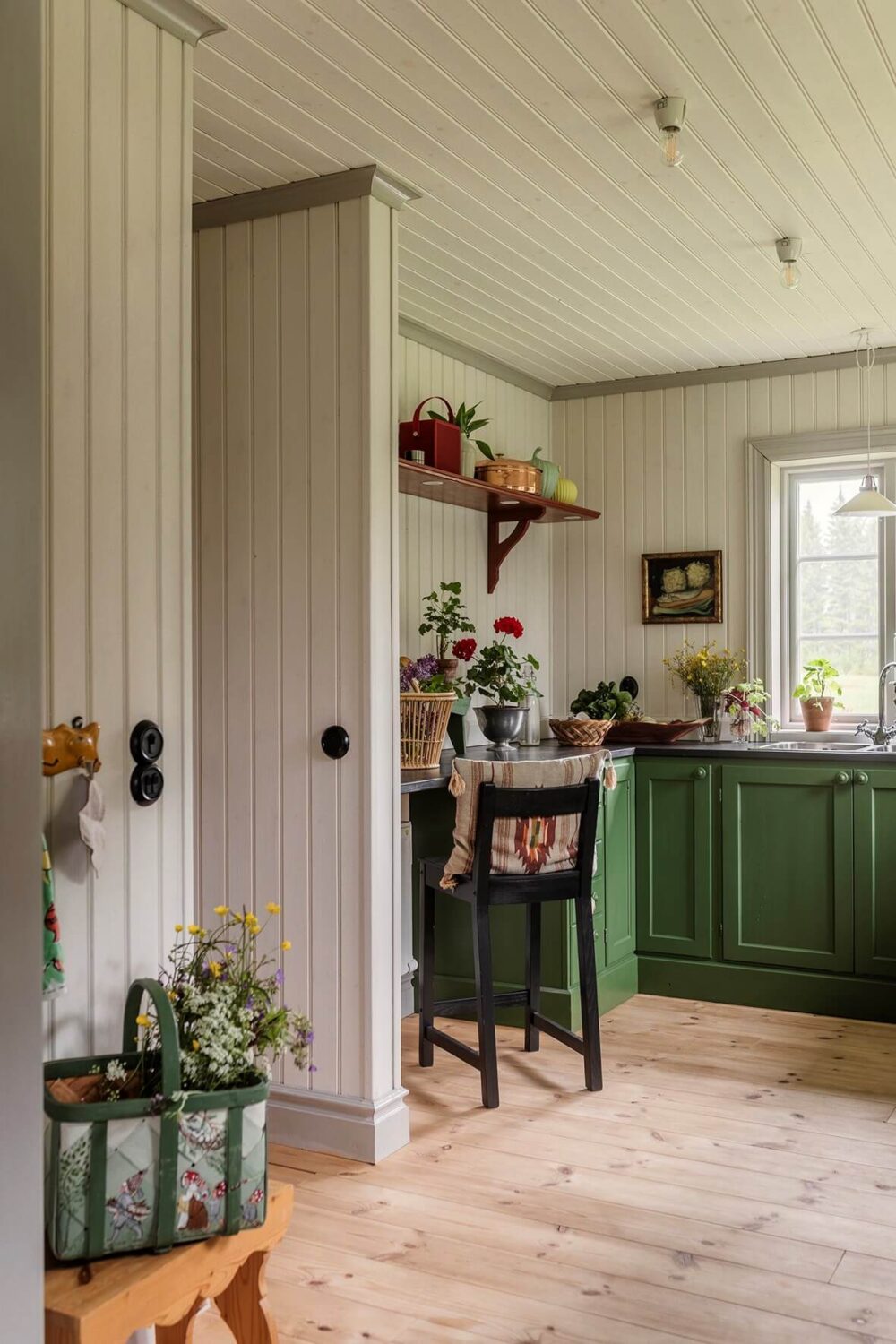 A Beautifully Preserved Historic Country House in Sweden 10 green kitchen tongue and groove paneling bar seating