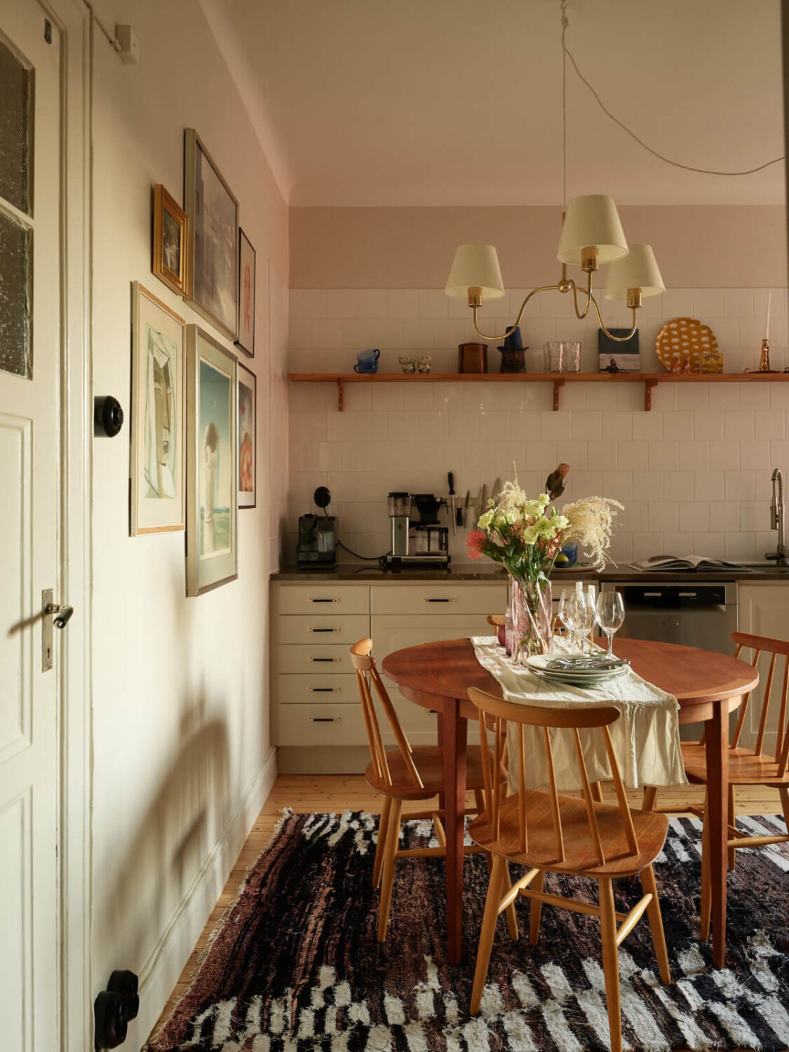 Historic Charm and an Industrial Glass Wall in a Stockholm Apartment 2 kitchen wooden table white backsplash tiles