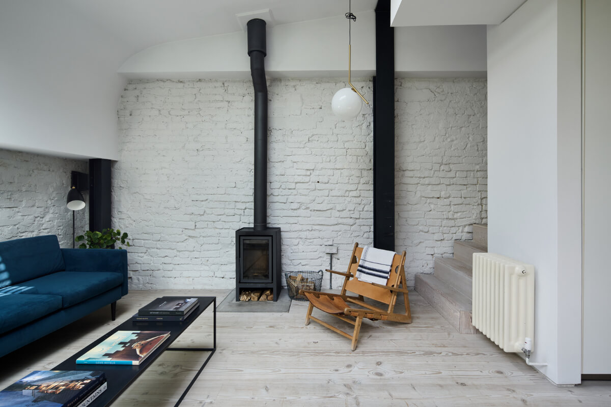 A Black and White Primrose Hill Mews House with a Roof Terrace 7 sitting room white painted brick wall