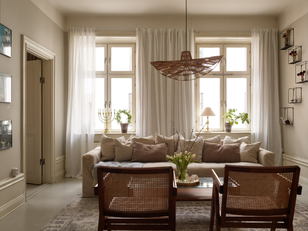 A Calm Gray Color Palette in a Charming Stockholm Apartment 1 light gray living room large windows A Calm Gray Color Palette in a Charming Stockholm Apartment