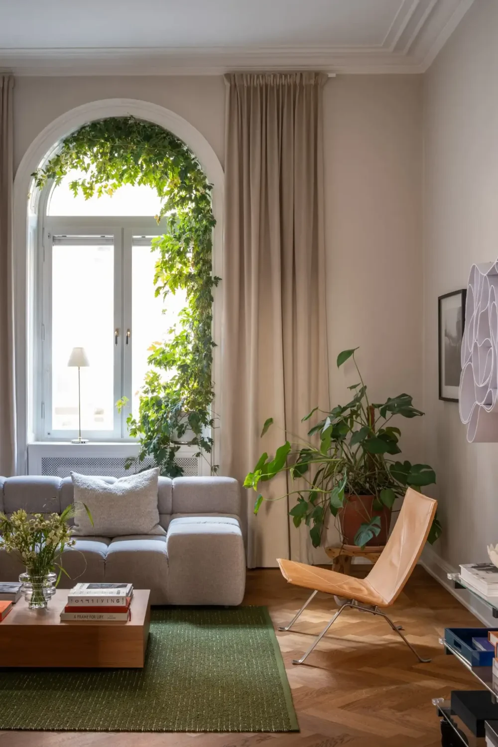 Arched Windows and Design Classics in a 19th Century Apartment 2 arched living room window plants