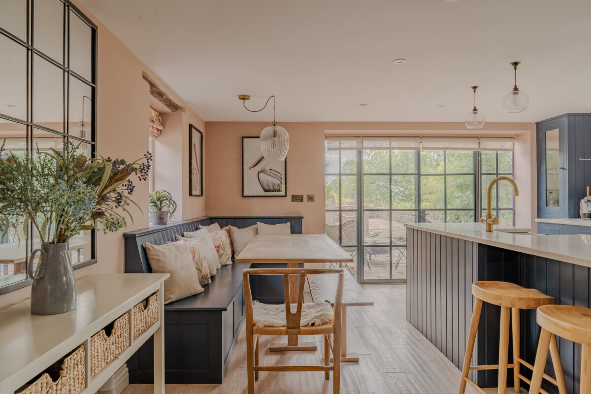 A Stone English Cottage with a Blue and Pink Kitchen 1 cottage kitchen pink walls blue cabinetry
