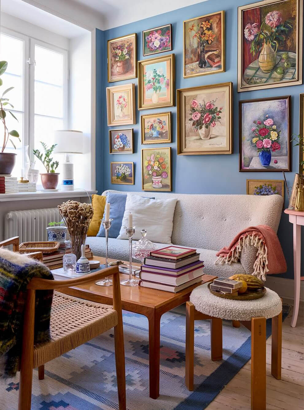 A Blue Living Room Filled with Art in a Swedish Apartment 3 gallery wall vintage floral art