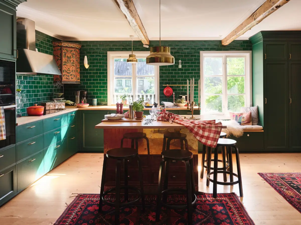 A Colorful Family Home in an Old Gardener's Cottage in Sweden 1 green kitchen with brass island