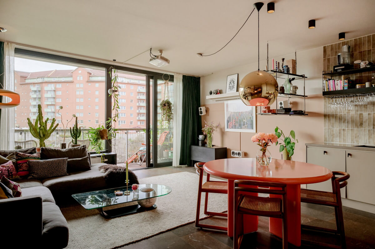 A Modern Swedish Apartment with Half-Painted Pink Walls 1 living room light pink walls pink dining table