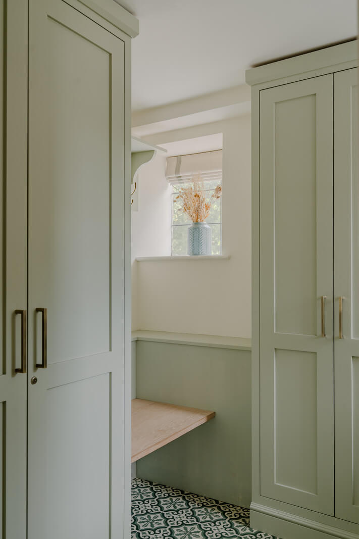 A Stone English Cottage with a Blue and Pink Kitchen 5 mint green utility room