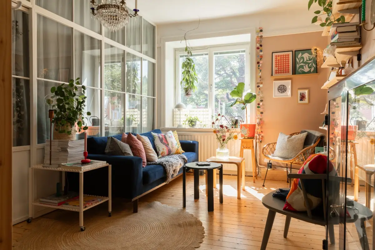 A Cozy Colorful Family Apartment with an Industrial Room Divider 1 pink scandinavian living room glass wall