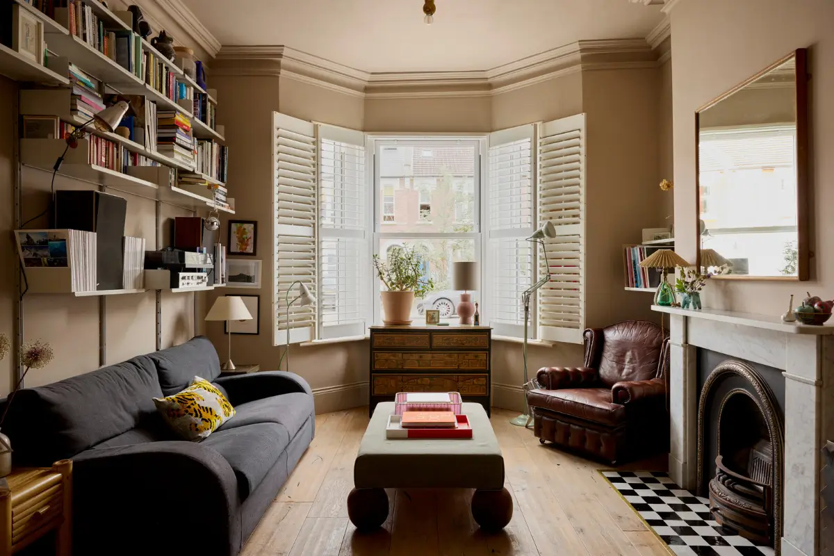 A Victorian Home with a Rich Color Palette and a Lush Garden 1 sitting room with bay window and marble fireplace