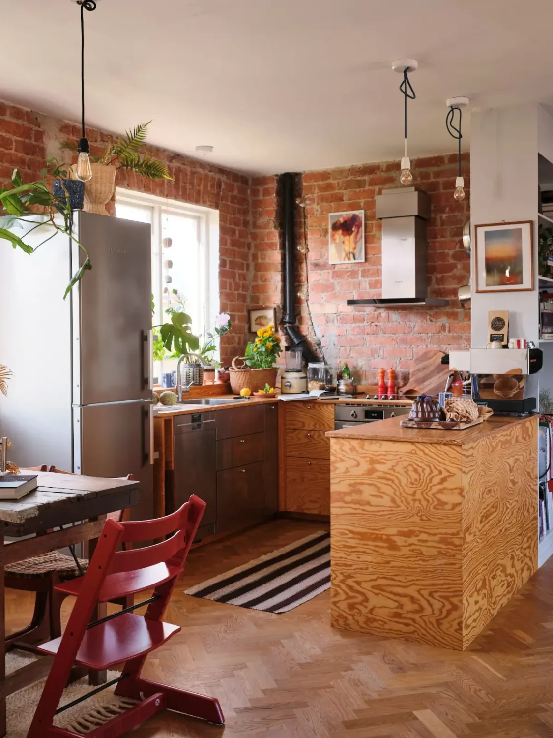 A Pink Bathroom and a Plywood Kitchen in a Stockholm Apartment 7 u-shaped wood kitchen exposed brick