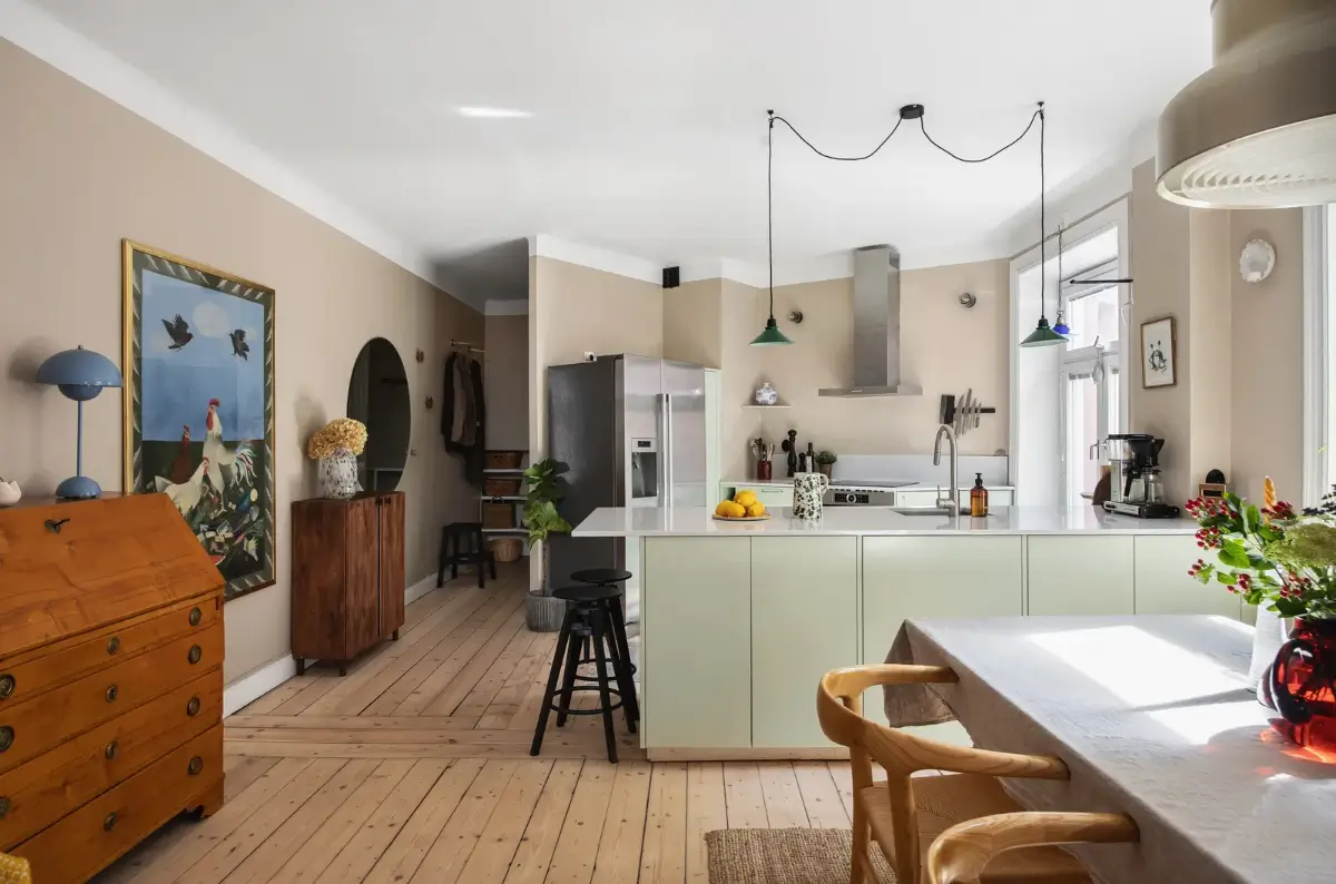 Warm Colors and an Open-Plan Living Space in a Stockholm Apartment 1 open-plan living space wooden floor mint green kitchen