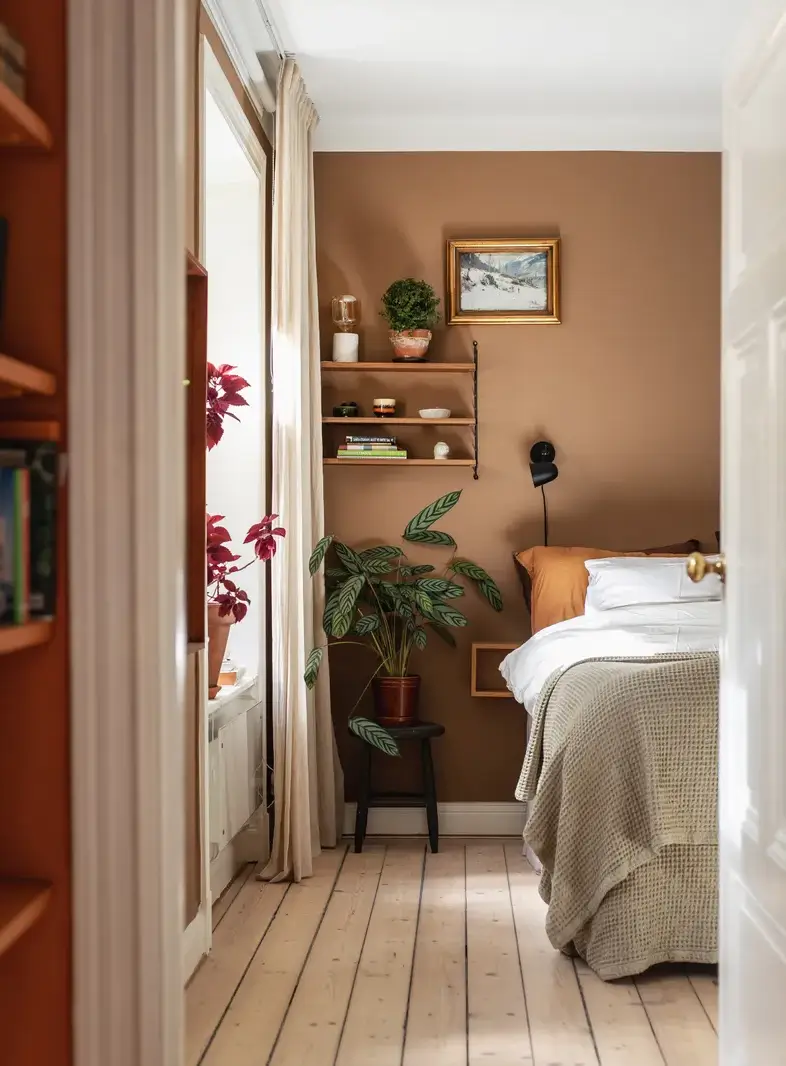 Warm Colors and an Open-Plan Living Space in a Stockholm Apartment 10 terracotta-colored bedroom wooden floor