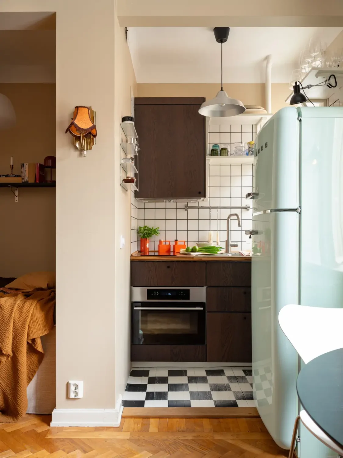 Warm Beige Walls and Practical Niches in a 1920s Studio Apartment 11 tiny walnut kitchen checkerboard floor