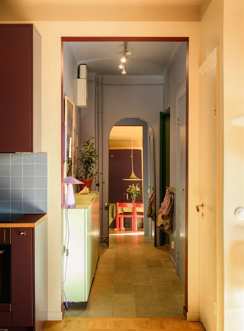 A Colorful Stockholm Family Apartment with Views of the Lake 31 blue tiled hallway with arched mirror nordroom