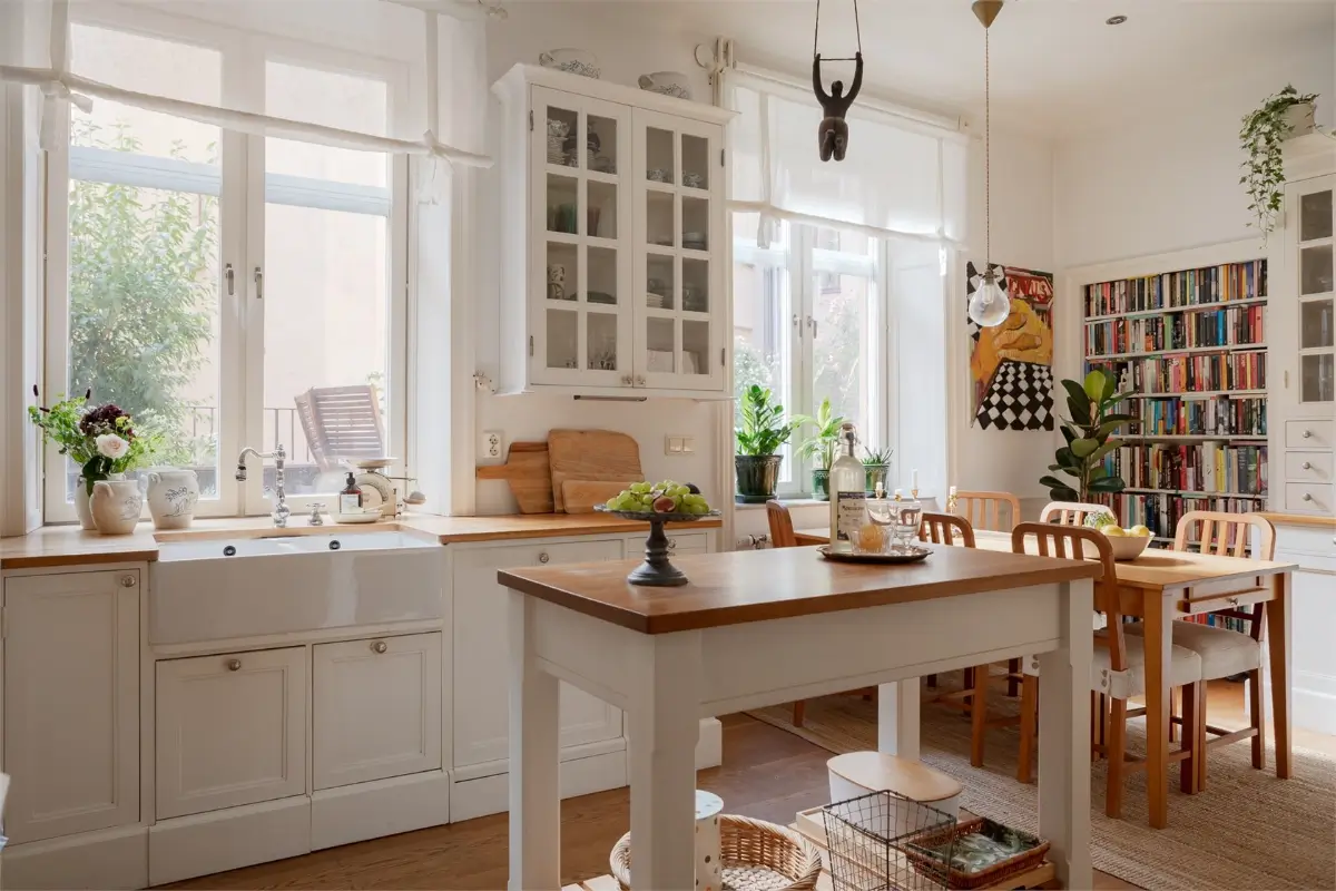 A Light-Filled Stockholm Apartment with a Charming Kitchen 1 classic white kitchen with island and butler sink
