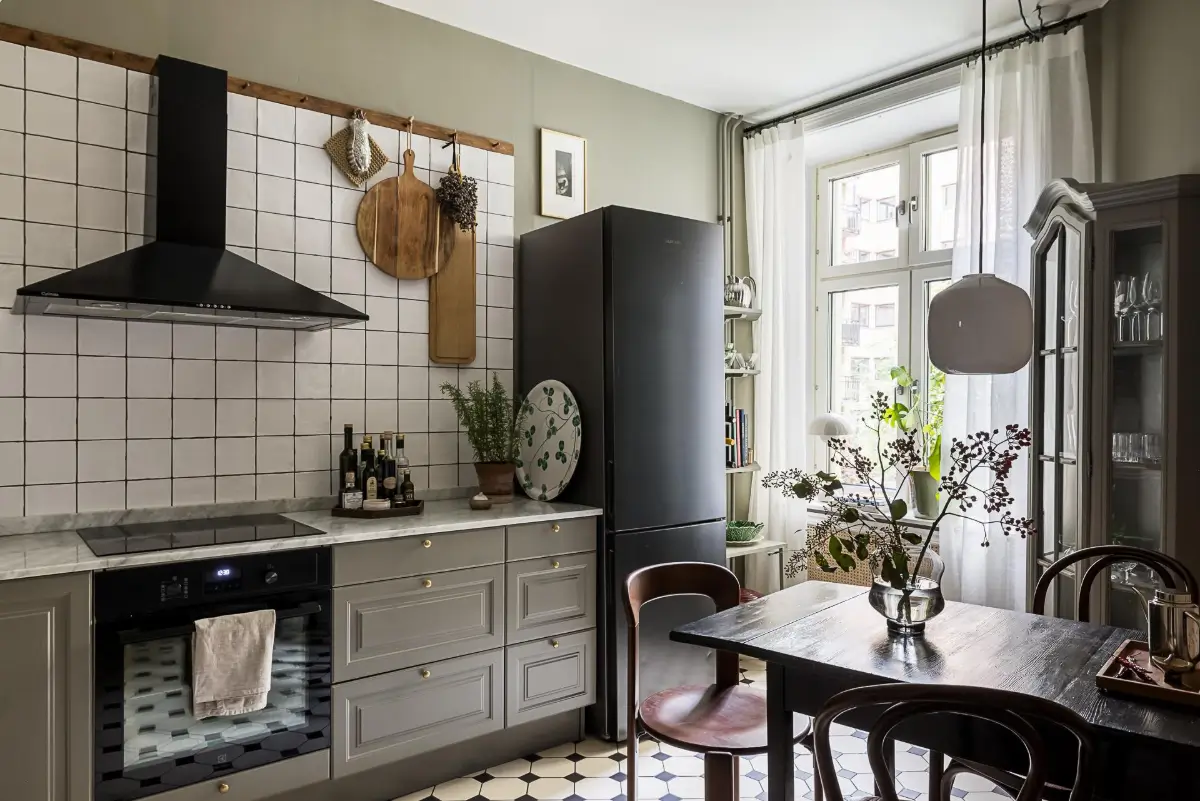 Gray Tones, Wallpapers, and a Mint Green Fireplace in a Swedish Apartment 23 cozy gray kitchen victorian floor tiles wooden table