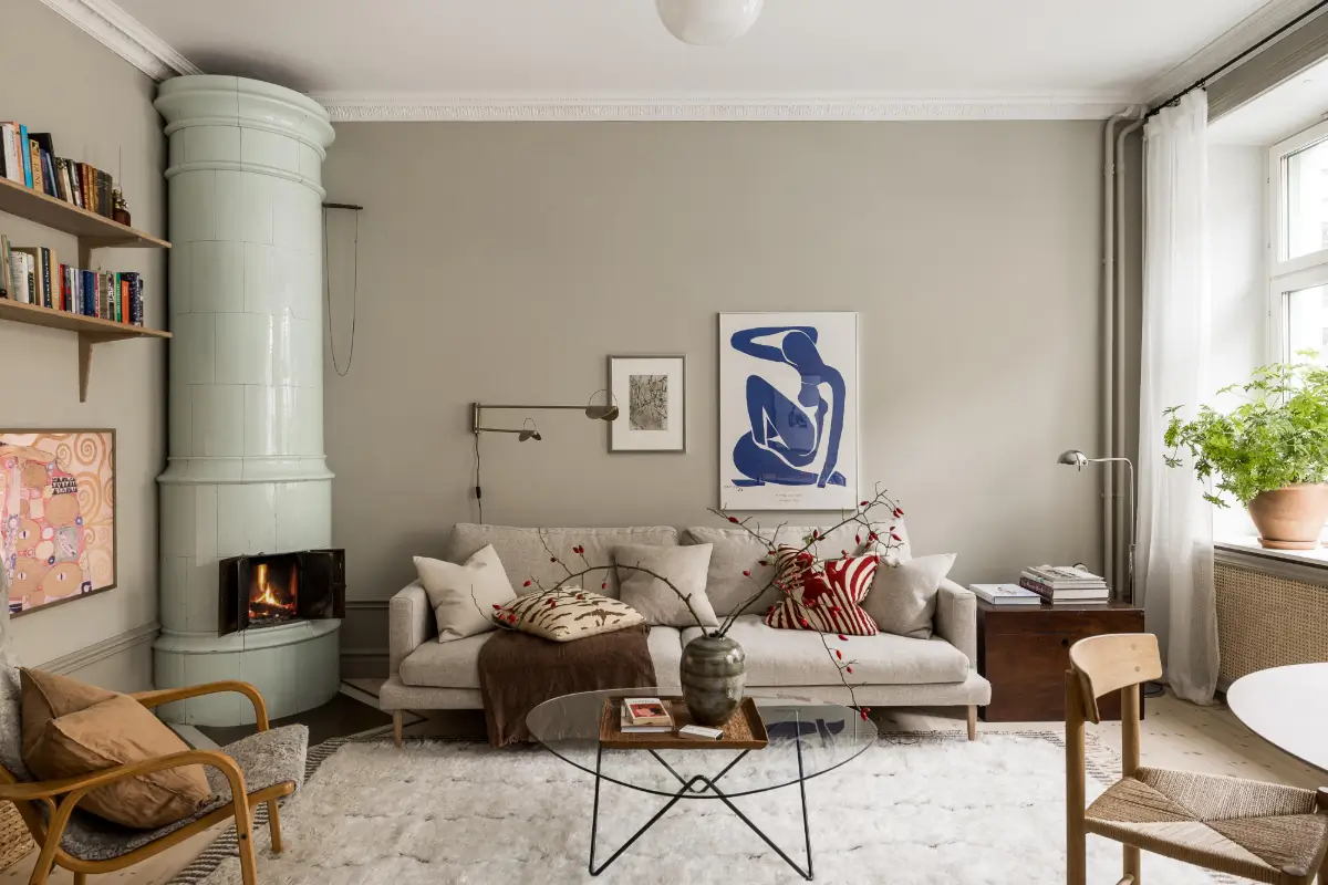 Gray Tones, Wallpapers, and a Mint Green Fireplace in a Swedish Apartment 1 gray scandinavian living room bookshelves mint green fireplace