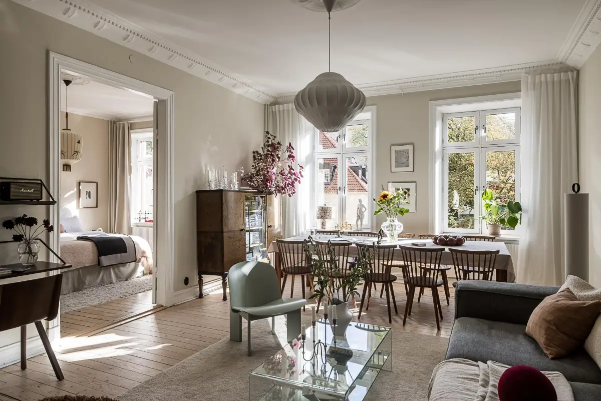 Warm Neutral Tones and Period Features in a Swedish Apartment 1 scandinavian living room large windows wooden floor