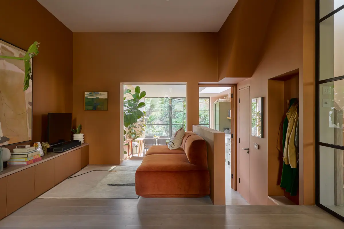 A Beautiful Victorian Townhouse Reimagined for Modern Living 5 television room terracotta sofa