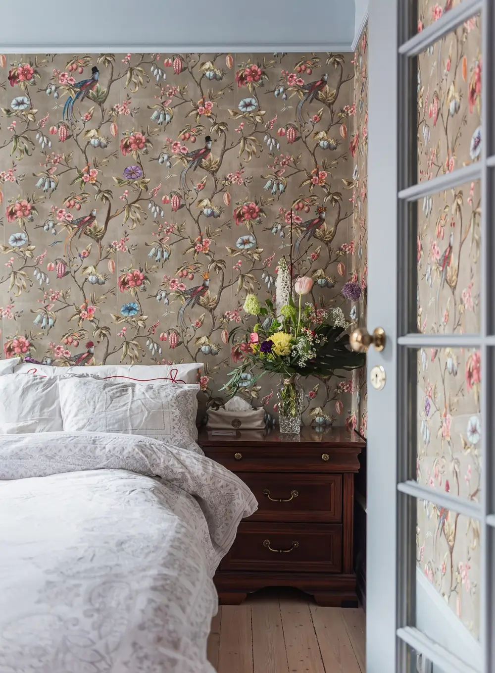 Whimsical Decor and Vibrant Color Accents in a Malmö Apartment 11 bedroom-floral-bird-wallpaper
