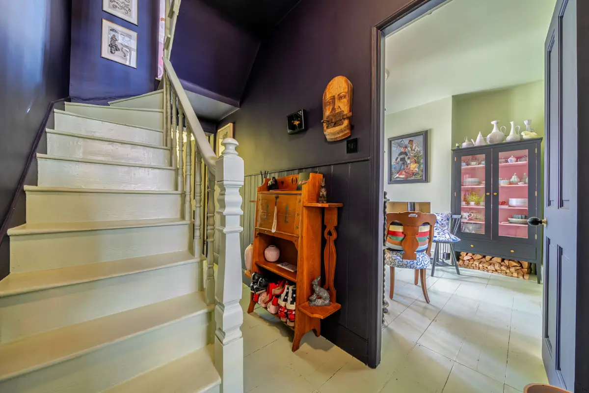 A London Family Home with a Pink deVOL Kitchen and Mint-Green Floorboards 7 dark-blue-hall-painted-floorboards