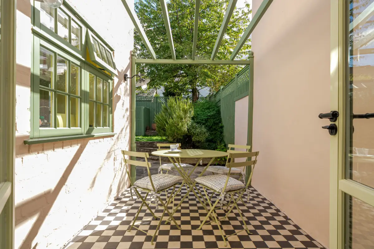 A London Family Home with a Pink deVOL Kitchen and Mint-Green Floorboards 16 patio-terrace-pink-walls-black-white-checkered-floor