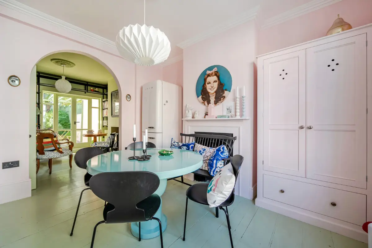 A London Family Home with a Pink deVOL Kitchen and Mint-Green Floorboards 5 round-kitchen-dining-table-green-floorboards-pink-walls